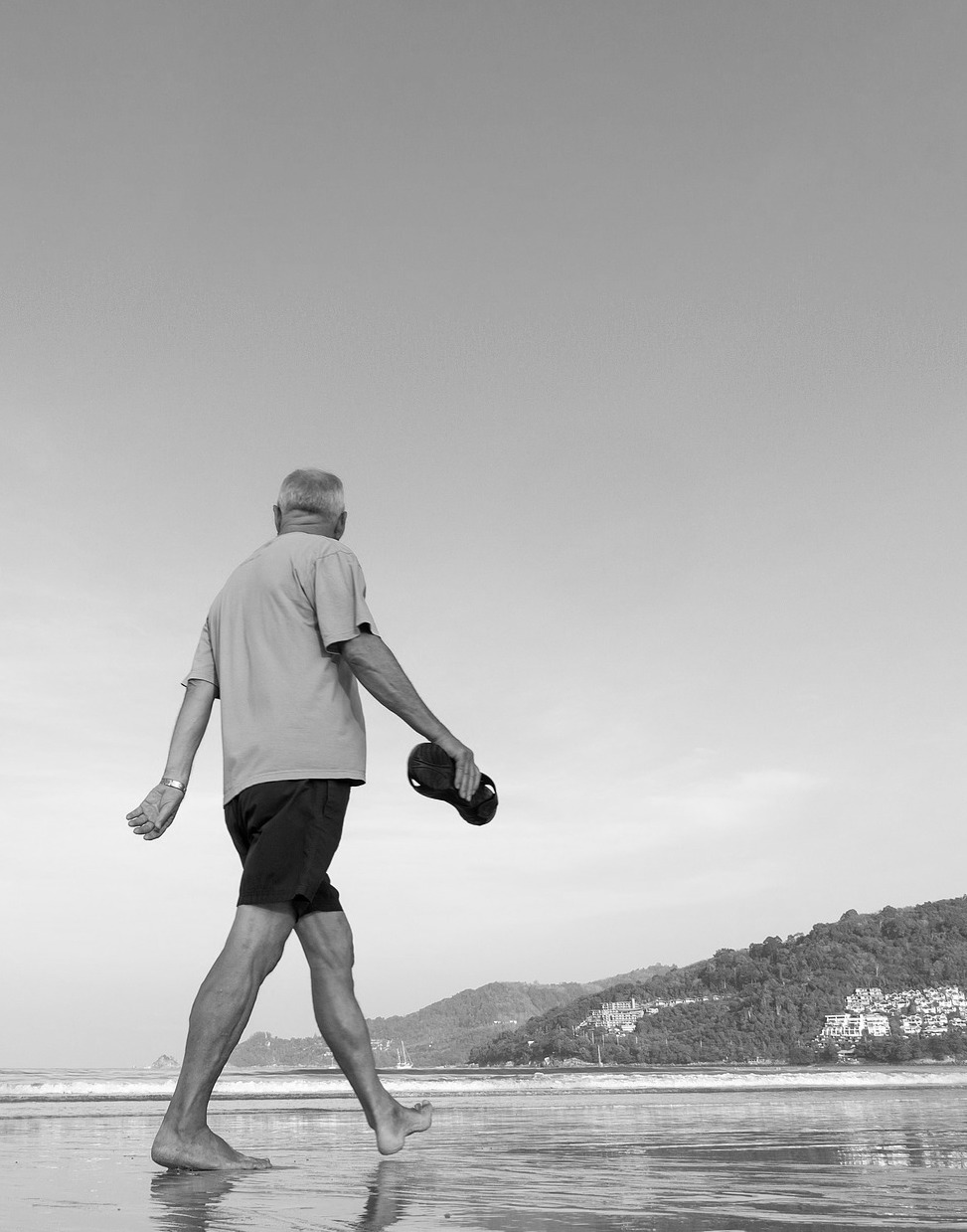 exercising later in life man walking on beach