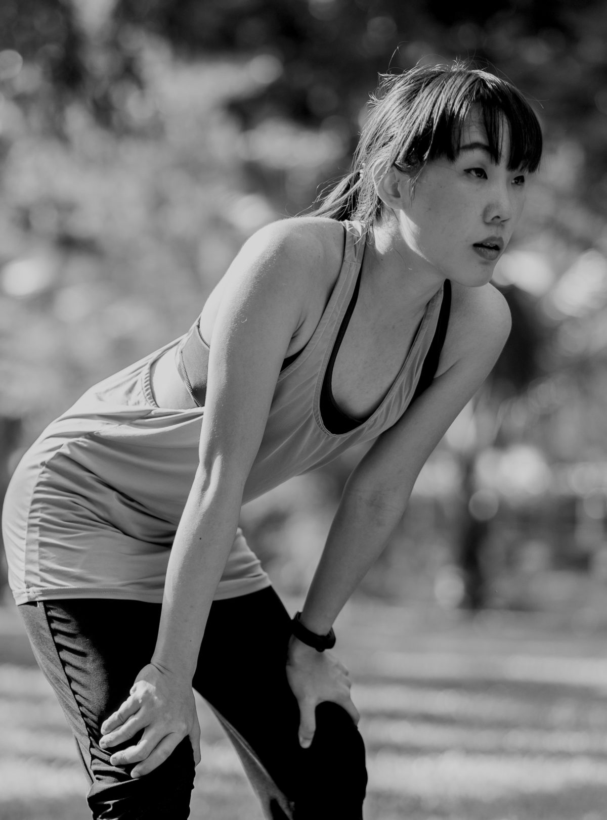 woman in workout clothes doing tips for crossfit workout recovery in a park