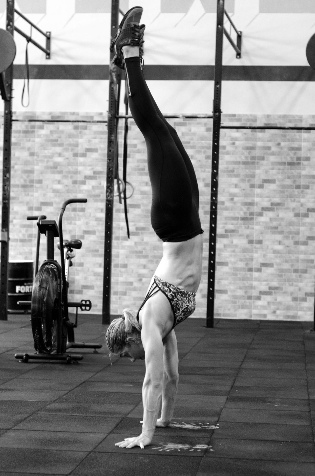 woman in gym doing benefits of gymnastics handstand