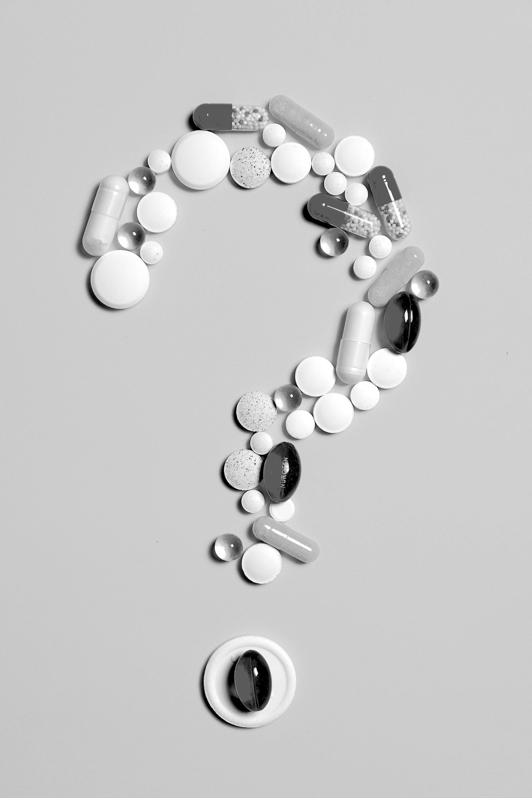 when to take workout supplements arranged in a question mark on a gray background